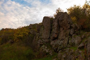 taş ridge bulutlu gökyüzü karşı bitki örtüsü ile büyümüş