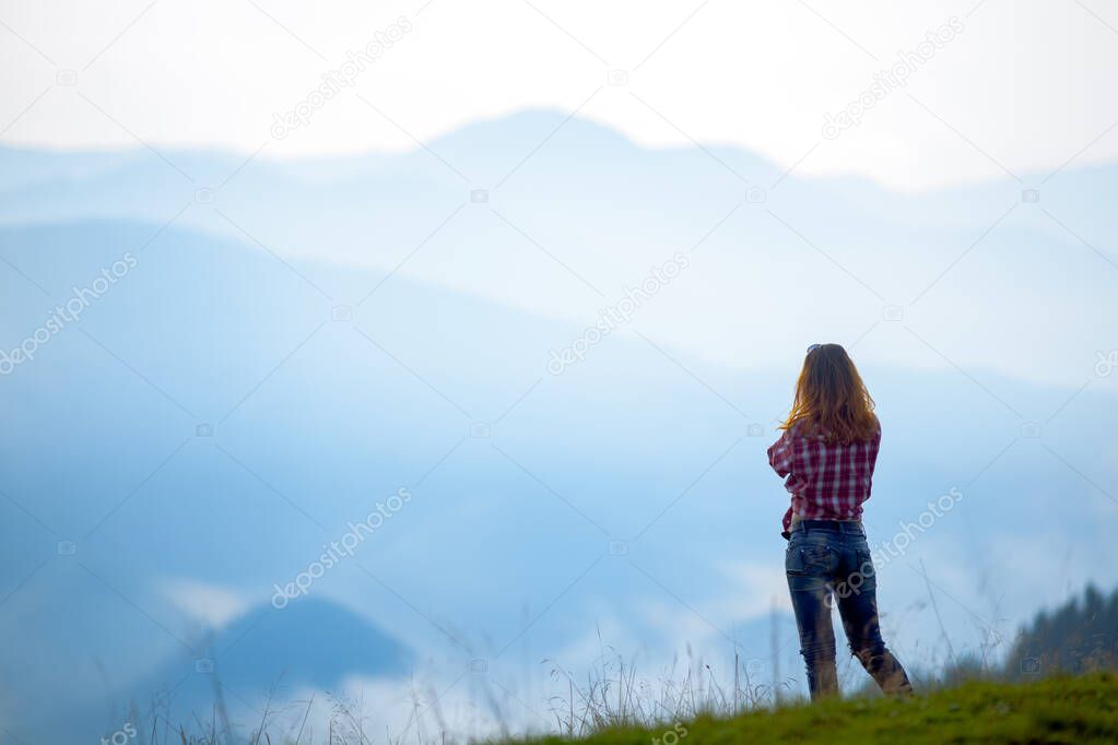 girl tourist high in the mountains sunset sun fog tops of the carpathians