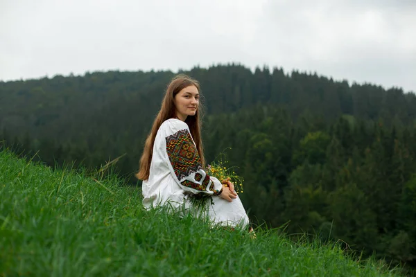 Dziewczyna Luźnymi Włosami Hafcie Bukietem Dzikich Kwiatów Siedzi Zielonej Trawie — Zdjęcie stockowe