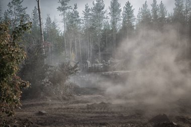 real battle panzer   in the Donbass - eastern Ukraine is driving fast in a coniferous forest clipart