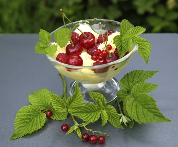 sweet cream ice cream in a crystal bowl with different berries