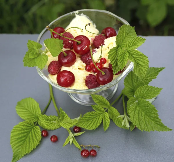 sweet cream ice cream in a crystal bowl with different berries