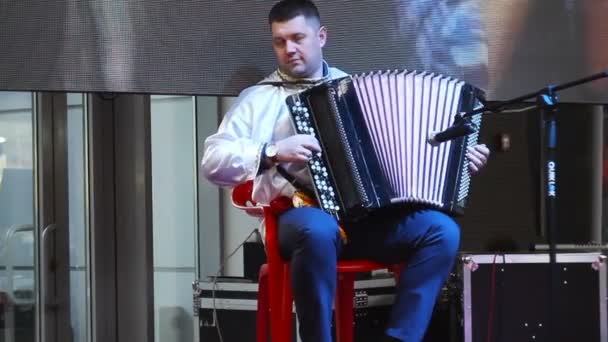 КУРСК, РОССИЯ - 18 февраля 2018 года: Музыкант играет на аккордеоне в праздничные дни — стоковое видео
