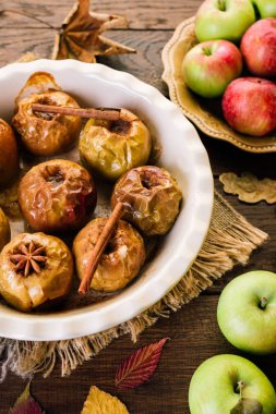 Pişmiş elma bir ahşap zemin üzerine tarçın anason ve sonbahar yaprakları
