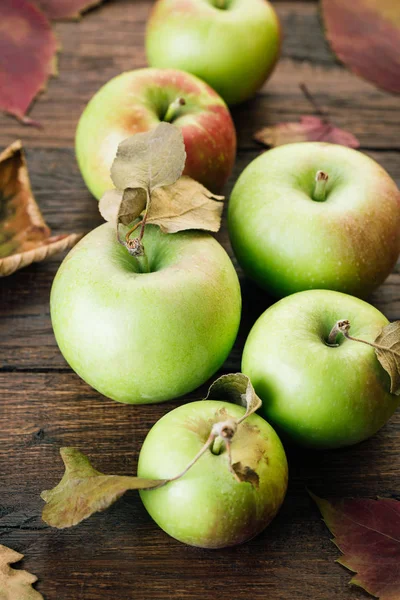 Green Apples and Fallen Leaves on Wooden Background Autumn Still Life