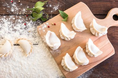 Mantı yemek bir yönetim kurulu ve ahşap arka plan, Ulusal Rus yemekleri, vareniki