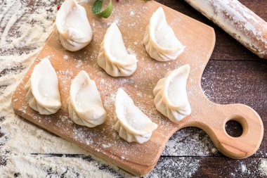 Mantı yemek bir yönetim kurulu ve ahşap arka plan, Ulusal Rus yemekleri, vareniki