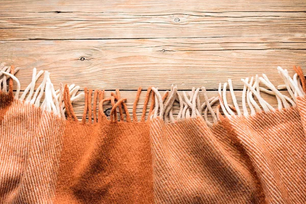 Warm wool throw on wooden background, blanket
