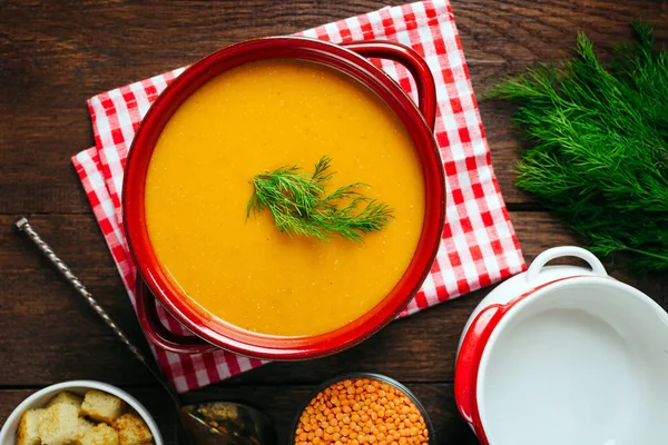 Lentil soup, red ceramic saucepan, wooden background, legumes, home cooking — Stock Image Lentil Soup Red Ceramic Saucepan Wooden Background Legumes Home Cooking Royalty Free Stock Photos