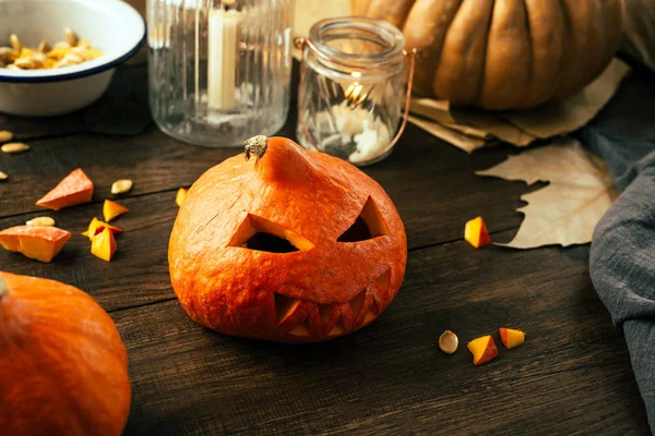 Preparing for the holiday Halloween, pumpkin, cut face, candles, wooden background