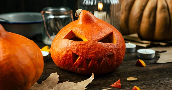 Preparing for the holiday Halloween, pumpkin, cut face, candles, wooden background