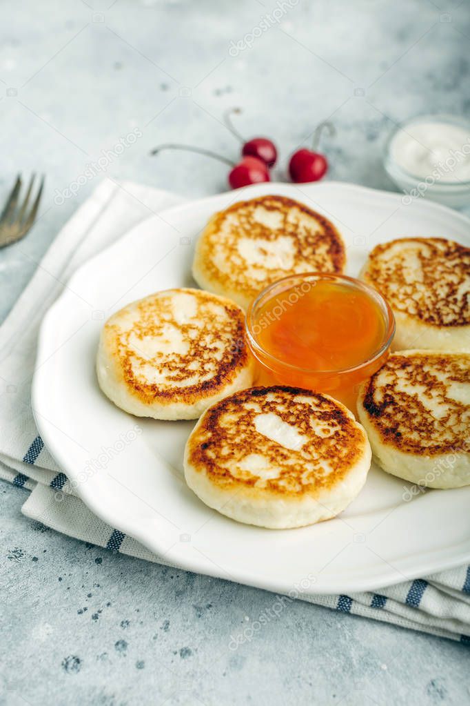 Cheesecakes, cottage cheese pancakes, delicious breakfast, apricot jam