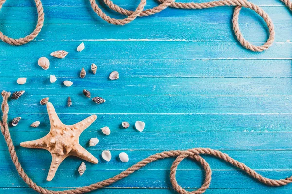 Nautical background, turquoise boards, rope, starfish