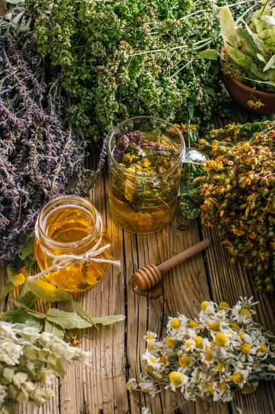Flower honey in a glass jar, harvesting wild medicinal herbs