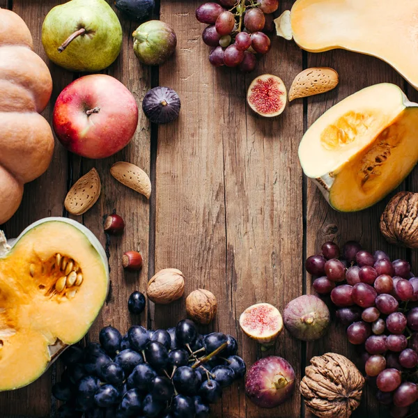 Food frame. Autumn vegetables. Pumpkin, Grapes, Figs