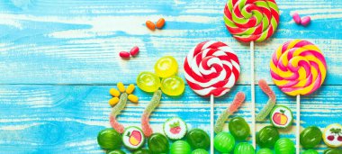 Tatlılar yaratıcı. Mavi arka planda lolipoplar. 