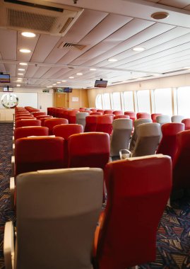 Red and gray empty seats in a ferry's passenger area