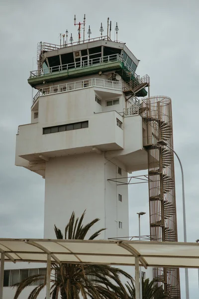 Airport control tower structure under cloudy sky