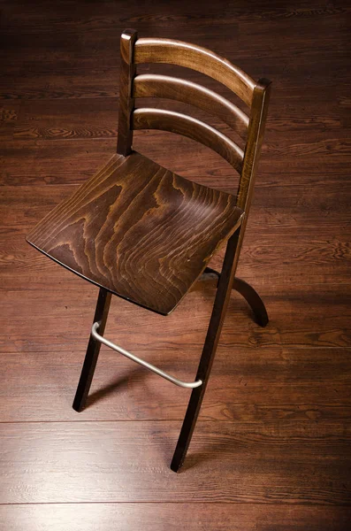 Wooden chair. Designer furniture.  Beautiful brown chair on the hardwood floor.
