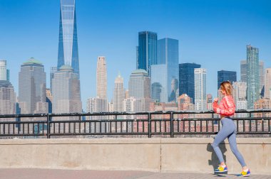 Healthy lifestyle. Woman is running in New York. Fitness sports runner is jogging in  the city clipart