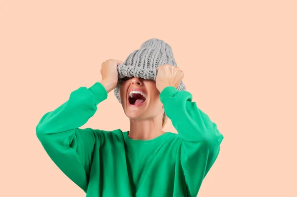 Furious Emotional Angry Woman Pulling Wool Hat Her Eyes Pastel — Stock Photo, Image