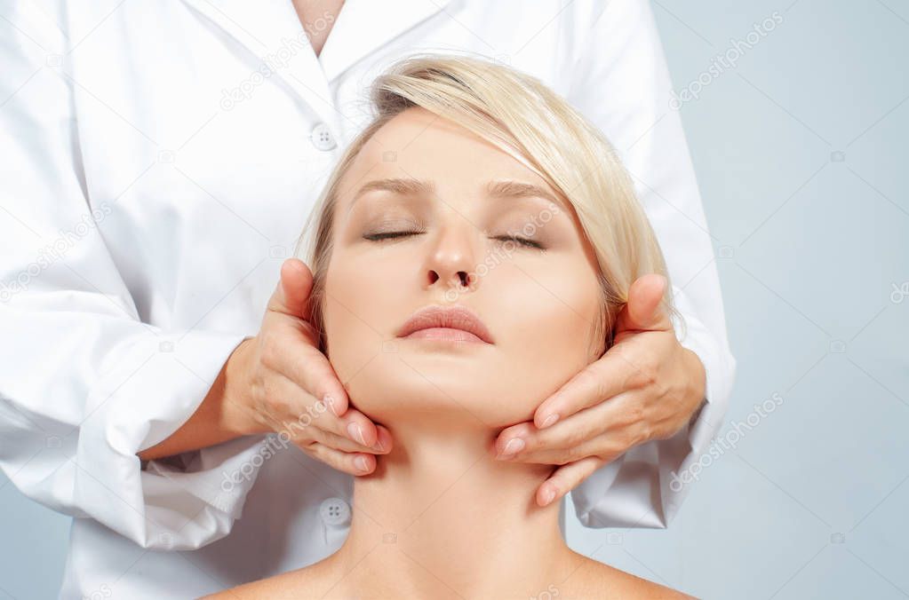 Beauty and facial treatment. Beautiful woman with clean perfect skin is getting face massage