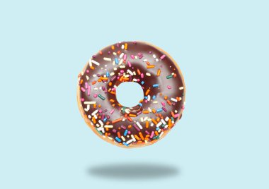 Chocolate donut on pastel blue background. clipart