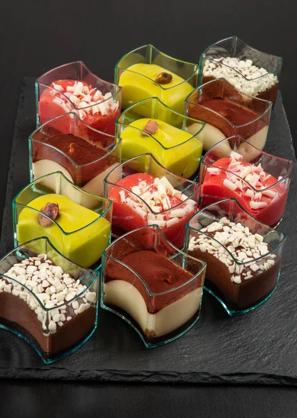 Mini dessert, tiramisu, chocolate and strawberry dessert on dark background.