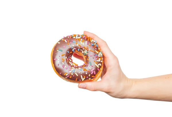 Mano femenina sosteniendo rosquilla colorida sobre fondo blanco pastel —  Fotos de Stock