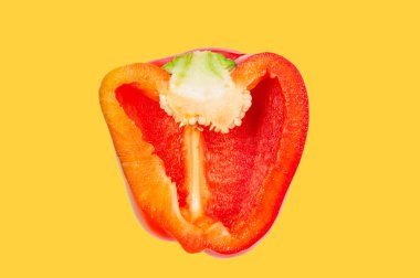 Sarı pastel arka planda havada yarım kırmızı biber havada havada havada. 