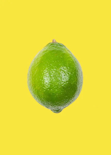 Lime levitate in air on yellow background. Concept of fruit levitation. — Stock Photo, Image