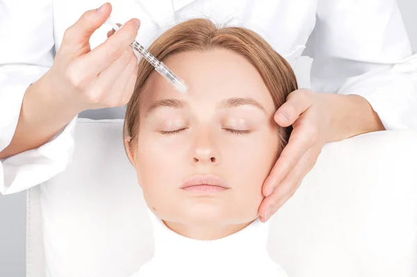 La mujer está recibiendo la inyección. Tratamiento antienvejecimiento y lifting facial. Inyección de lifting facial de la piel en la cara de la mujer . — Foto de Stock