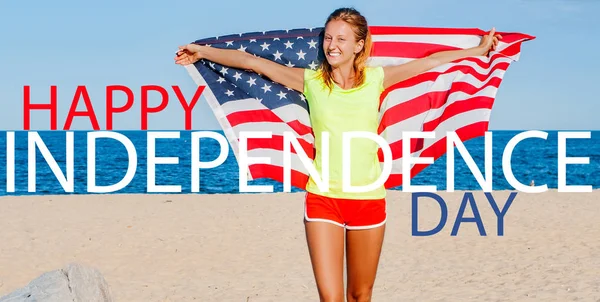 Happy Independence day. 4th of July  Beautiful cheerful woman holding an American flag on the beach. — Stok fotoğraf