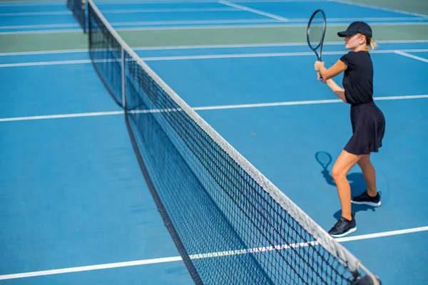 Ung sport kvinna spela tennis på den blå tennisbanan — Stockfoto