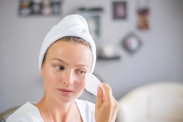 Face massage. Beautiful woman is getting massage face using jade stone for skin care — Stock Image Face massage. Beautiful woman is getting massage face using jade stone for skin care Stock Picture