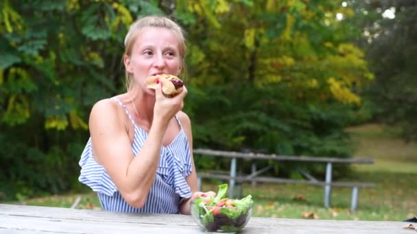 Dışarıda Oturan Hotdog Yiyen Kadın — Stok video