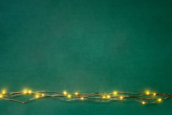 Boże Narodzenie Świateł Girlanda Granicy Nad Zielonym Tle Płaskie Lay — Zdjęcie stockowe