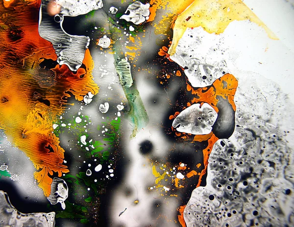 Colored liquids mixed together in fluid creating colorful abstract painting