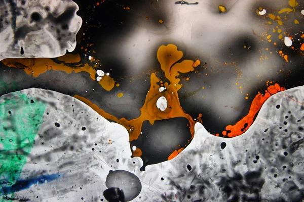 Colored liquids mixed together in fluid creating colorful abstract painting