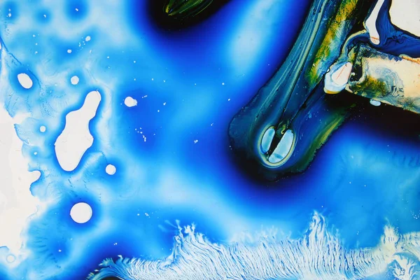 Colored liquids mixed together in fluid creating colorful abstract painting