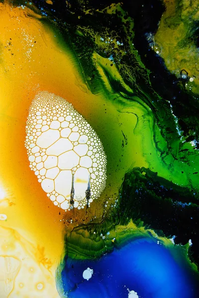 Colored liquids mixed together in fluid creating colorful abstract painting