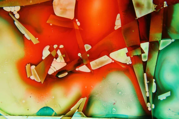 Colored liquids mixed together in fluid creating colorful abstract painting