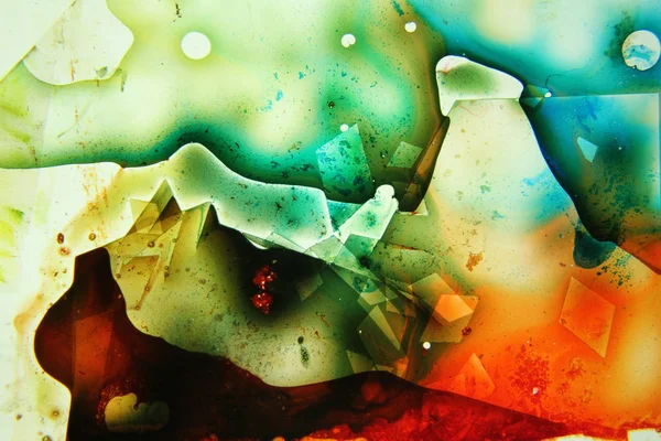 Colored liquids mixed together in fluid creating colorful abstract painting