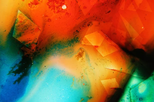 Colored liquids mixed together in fluid creating colorful abstract painting