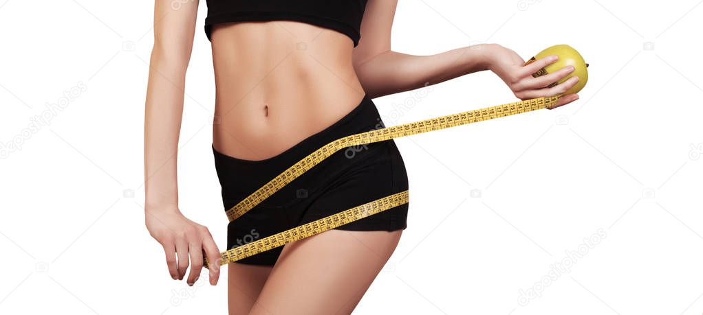 Woman measuring her waist. Perfect Slim Body. Diet. Slim body, isolated on white, copy space. Fit fitness girl measuring her waistline with measure tape. Fintess, diet and healthy lifestyle concept