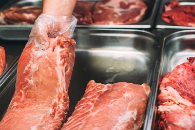 Kasap. Kasap et parçası dükkanda holding eller. Taze et süpermarkette sergilenen en iyi teklif. Ham sığır eti ve domuz eti dükkanda. Çiğ et çeşitli. Taze domuz market