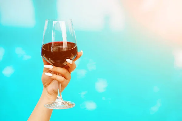 Female Hand Holding Glass Red Wine Turquoise Water Background Travel — Stock Photo, Image