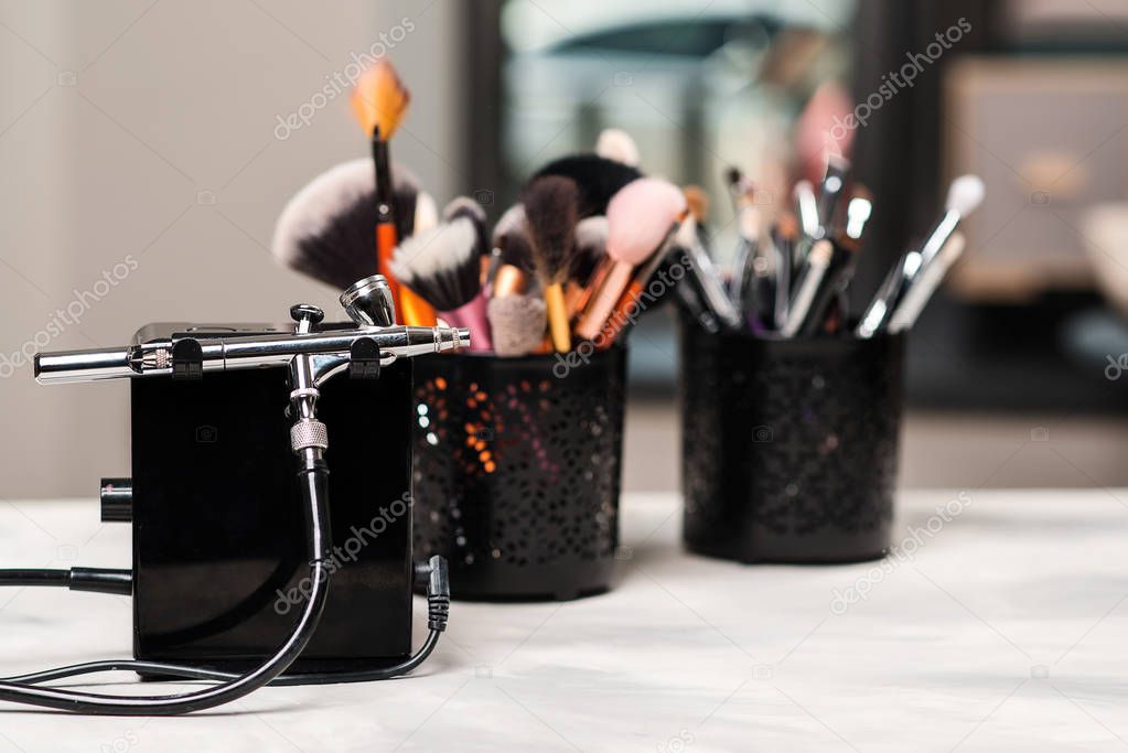 Beauty and fashion. Makeup tools and brushes on artist workplace. Makeup products set. 