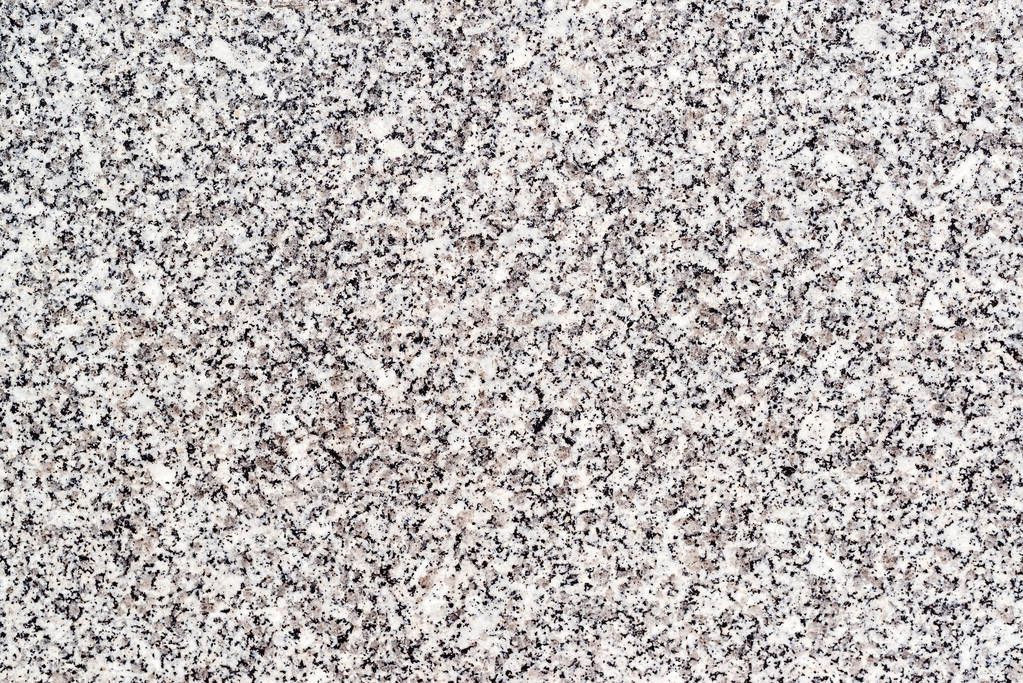 Non polished granite background. Closeup of grey granite texture background
