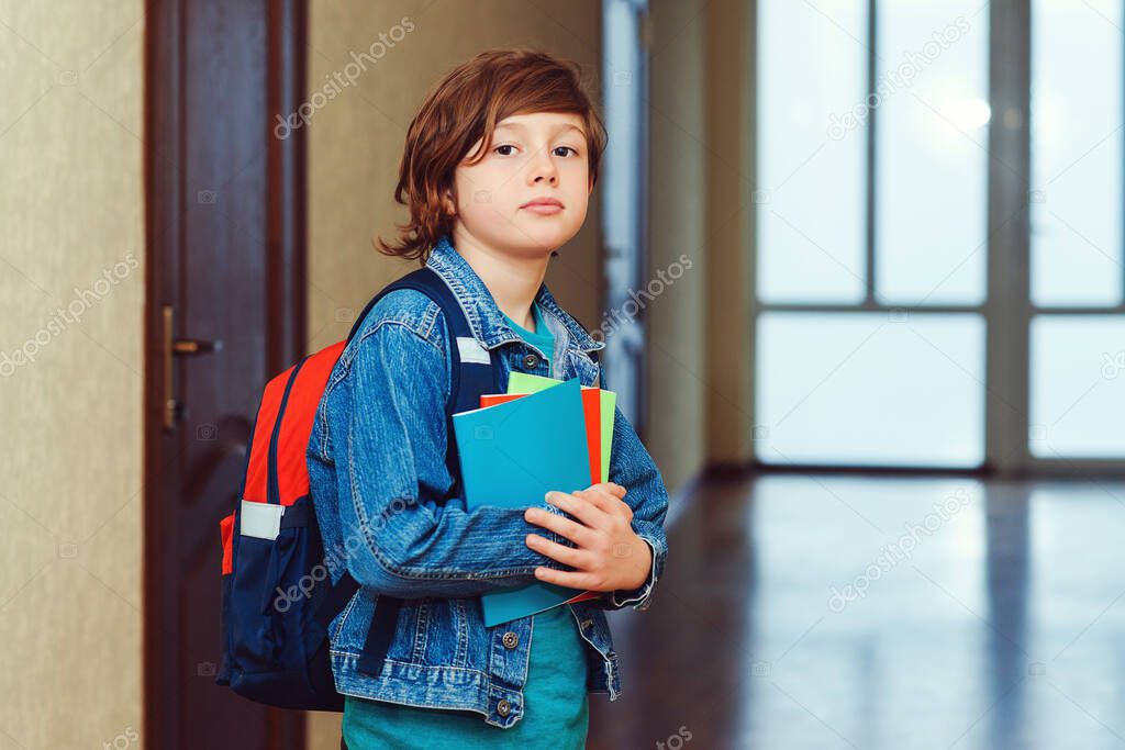 Young student with schoolbag and notebooks. Smart schoolboy looking at camera. Education concept. Back to school. Schoolkid going to class. Cute school boy with backpack.